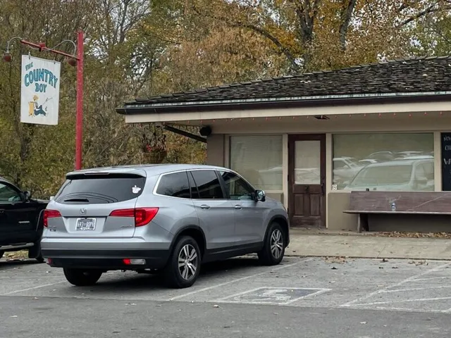 The diner’s front door and bench in 2022, before the reopening, the older blue-and-white fisherman sign above.
